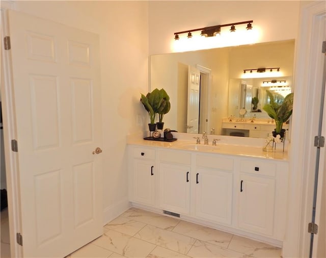 bathroom featuring marble finish floor and vanity