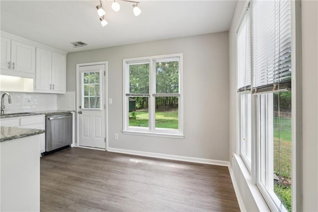 kitchen with white cabinetry, dark wood finished floors, a sink, and dishwasher