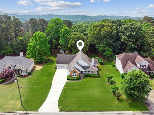 birds eye view of property with a forest view