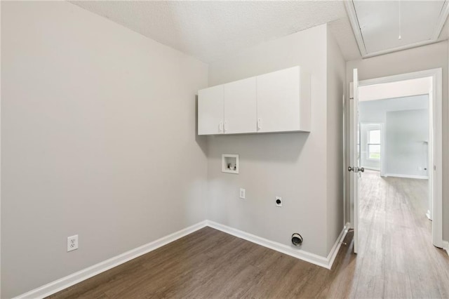 laundry area featuring attic access, dark wood-style floors, hookup for an electric dryer, cabinet space, and washer hookup