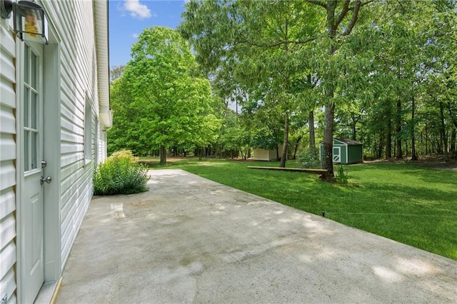 view of patio featuring a storage shed and an outbuilding