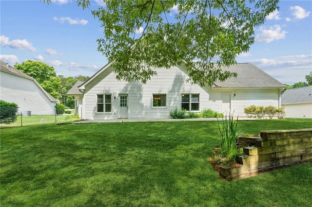 rear view of house with a yard
