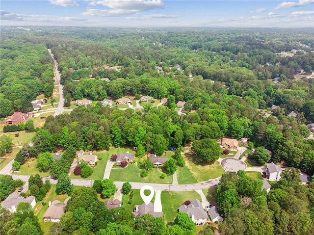 drone / aerial view featuring a view of trees and a residential view