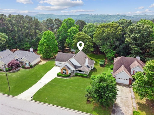birds eye view of property with a wooded view