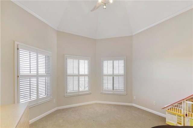 spare room featuring ceiling fan, ornamental molding, light carpet, and a wealth of natural light