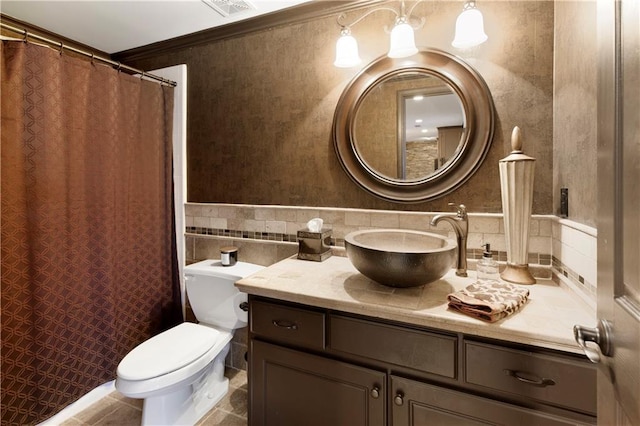 bathroom with decorative backsplash, toilet, vanity, and ornamental molding