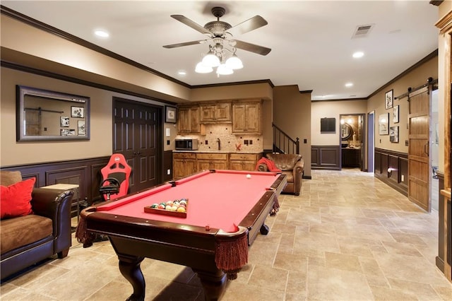 recreation room featuring ceiling fan, crown molding, sink, a barn door, and billiards