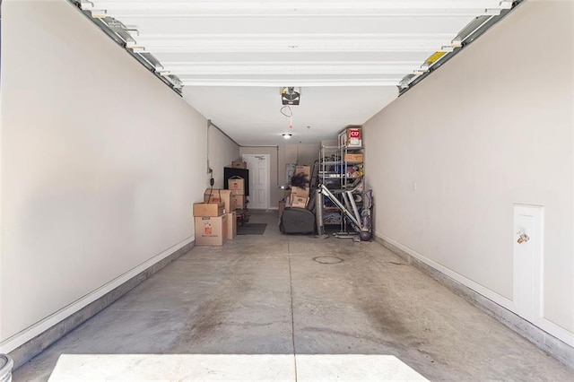 garage featuring baseboards and a garage door opener