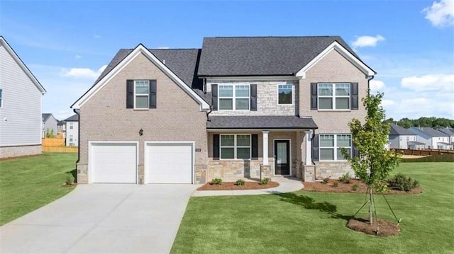 view of front of home featuring a garage, a front lawn, and covered porch