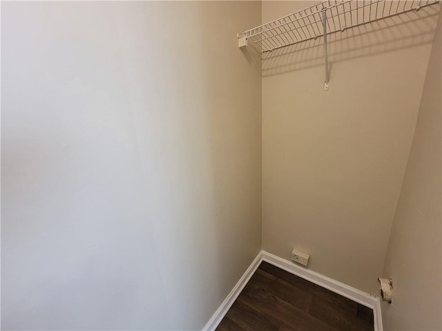 laundry area with dark hardwood / wood-style flooring