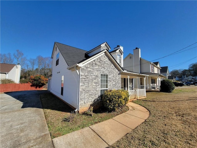 view of side of home with a porch and a garage