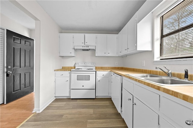 kitchen with white appliances, a sink, white cabinets, and under cabinet range hood