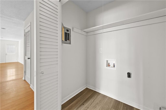 washroom with hookup for a washing machine, laundry area, wood finished floors, and hookup for an electric dryer