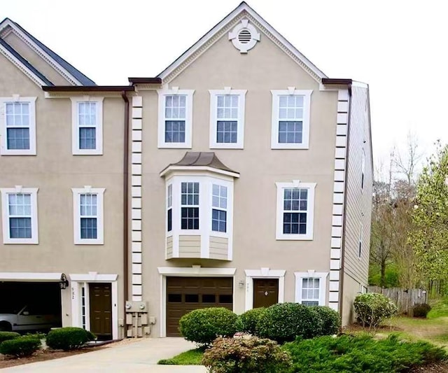 988 Vintage Pointe Dr, Lawrenceville, GA 30044 - view of front facade featuring driveway, a garage, and stucco siding