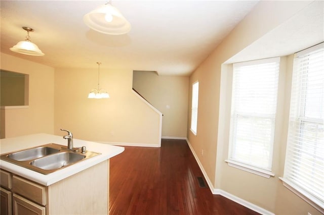 988 Vintage Pointe Dr, Lawrenceville, GA 30044 - kitchen with baseboards, dark wood-style floors, light countertops, pendant lighting, and a sink