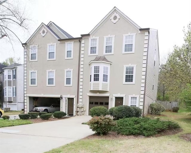 988 Vintage Pointe Dr, Lawrenceville, GA 30044 - townhome / multi-family property with a garage, stucco siding, and concrete driveway
