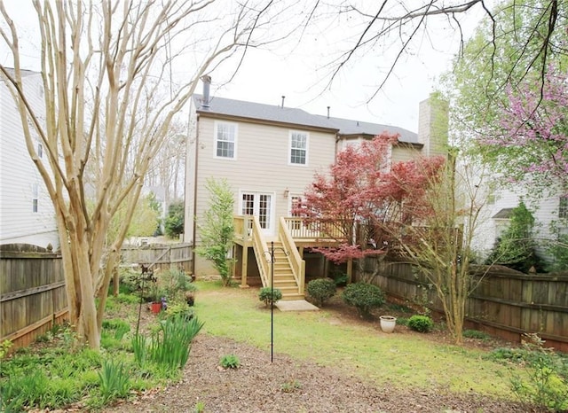 988 Vintage Pointe Dr, Lawrenceville, GA 30044 - back of house featuring a lawn, a chimney, a fenced backyard, stairs, and a wooden deck