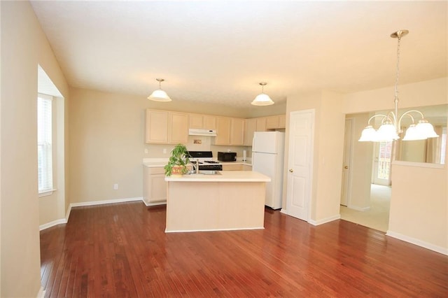 988 Vintage Pointe Dr, Lawrenceville, GA 30044 - kitchen featuring freestanding refrigerator, under cabinet range hood, dark wood-style flooring, light countertops, and a notable chandelier