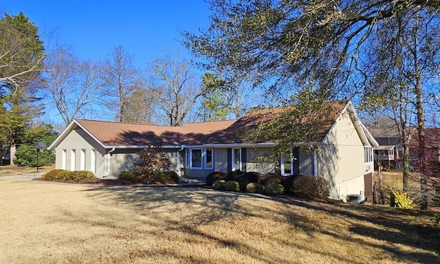 ranch-style home with central AC and a front lawn