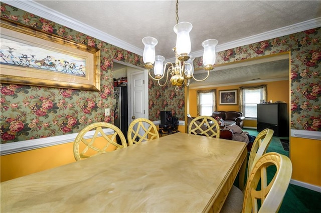 dining room featuring a textured ceiling, crown molding, and a chandelier