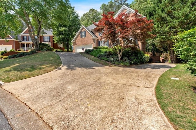 view of front of property with a garage, a front yard, and concrete driveway