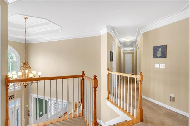 hallway featuring crown molding, an upstairs landing, and carpet