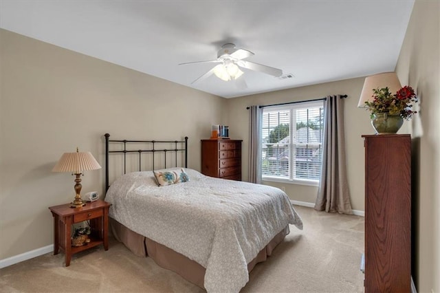 bedroom with baseboards, visible vents, ceiling fan, and light colored carpet