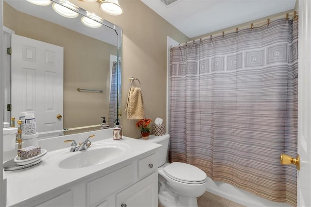 bathroom featuring vanity, tile patterned flooring, and toilet