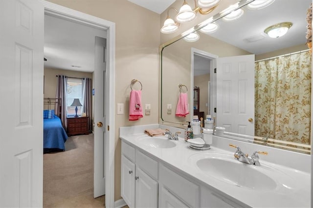 ensuite bathroom featuring a sink, ensuite bathroom, and double vanity