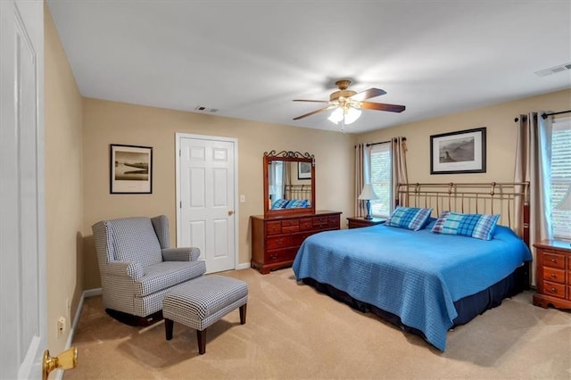 bedroom featuring visible vents, multiple windows, and light colored carpet