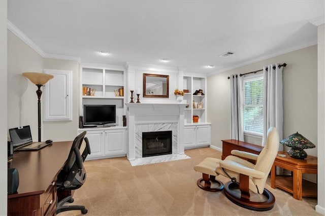 office with light colored carpet, a fireplace, baseboards, visible vents, and ornamental molding