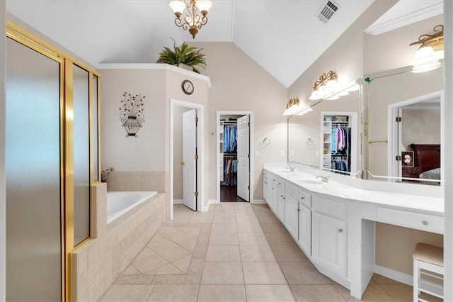 full bath with visible vents, a walk in closet, and tile patterned floors