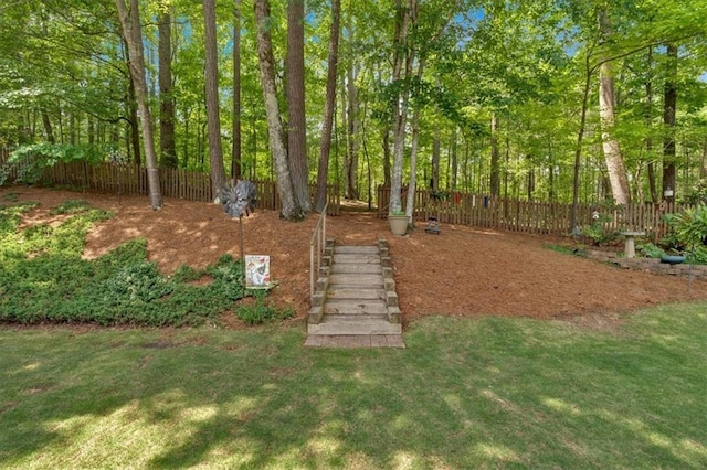 view of yard featuring stairway and fence