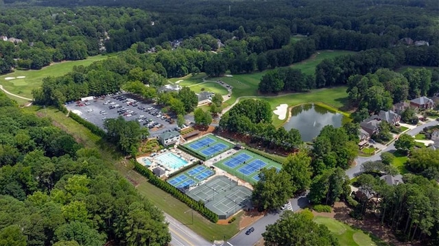 aerial view featuring view of golf course, a water view, and a wooded view