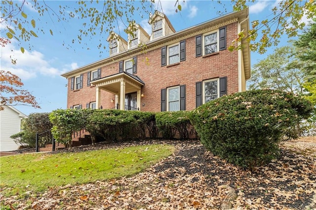 colonial-style house with a front yard