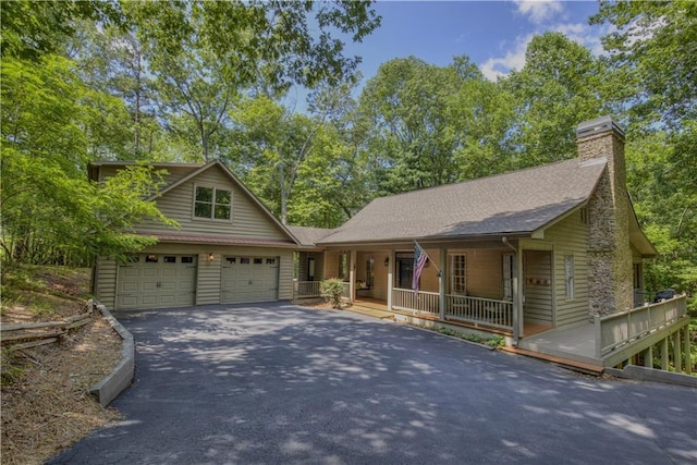 208 Trout Lily Trl, Big Canoe, GA 30143 - view of front of property with asphalt driveway, covered porch, a shingled roof, and a chimney