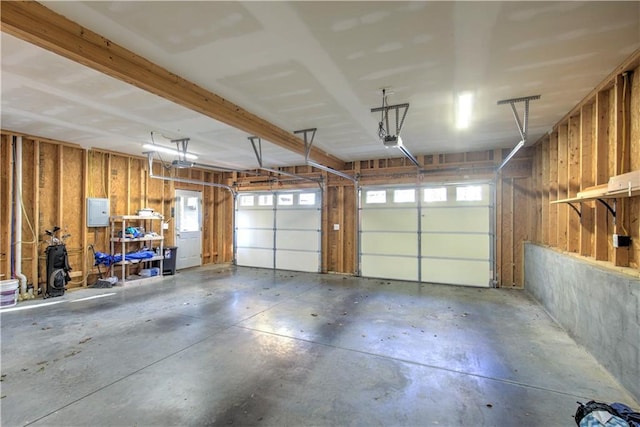 garage featuring electric panel and a garage door opener