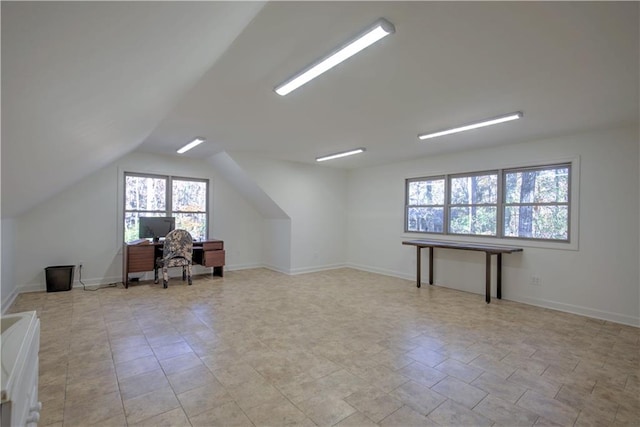 unfurnished office featuring vaulted ceiling