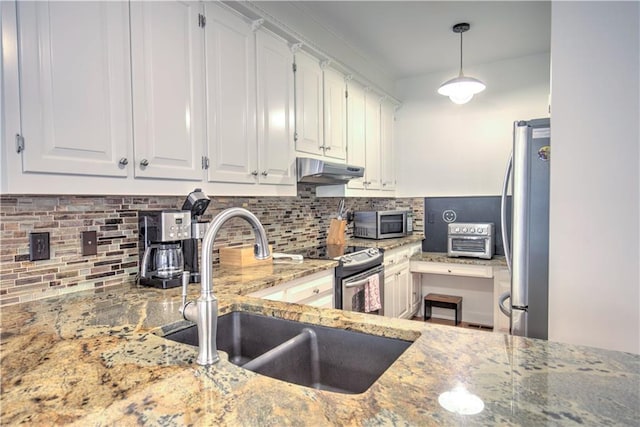 kitchen with sink, stainless steel appliances, backsplash, pendant lighting, and white cabinets