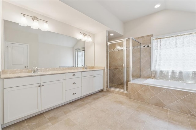 bathroom featuring lofted ceiling, a shower stall, a bath, double vanity, and recessed lighting