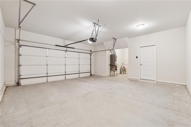 garage featuring water heater, a garage door opener, and baseboards