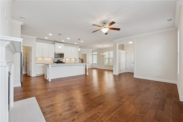 unfurnished living room with crown molding, a ceiling fan, recessed lighting, a chandelier, and dark wood-style flooring