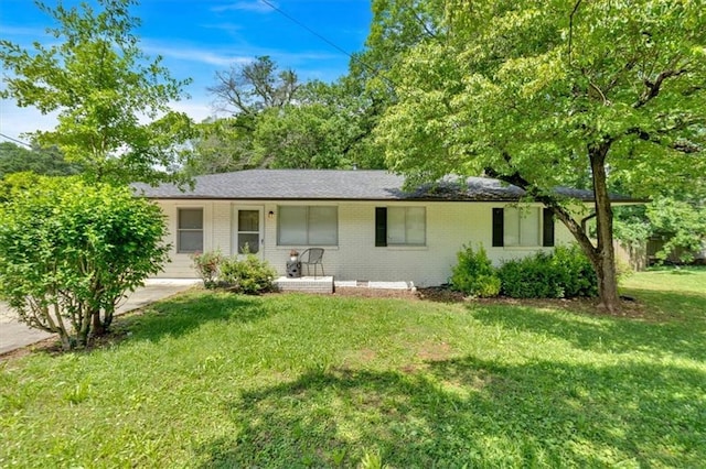 ranch-style home with brick siding, a front lawn, and covered porch