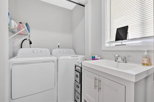 laundry area with a sink and washing machine and dryer
