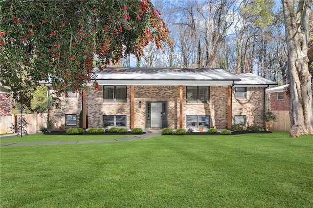 split foyer home with a front lawn