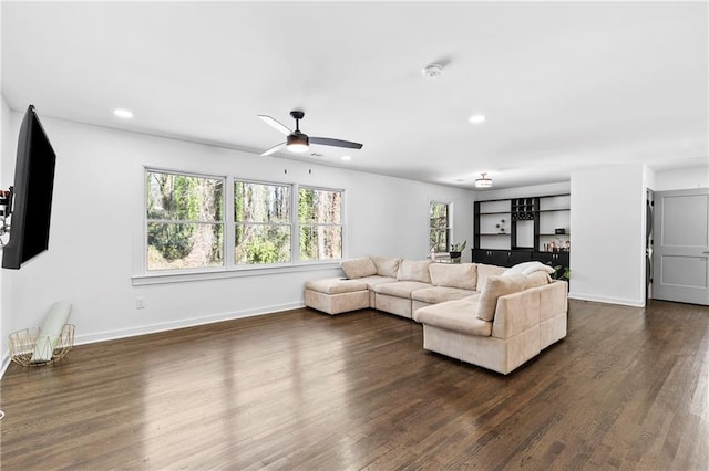 living room with dark hardwood / wood-style floors and ceiling fan