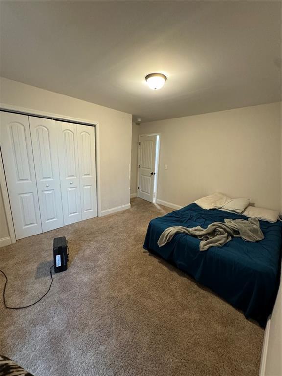 carpeted bedroom with a closet