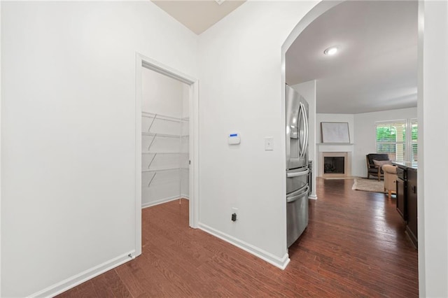 123 Meridian Dr, Woodstock, GA 30188 - hallway featuring arched walkways, dark wood-type flooring, and baseboards