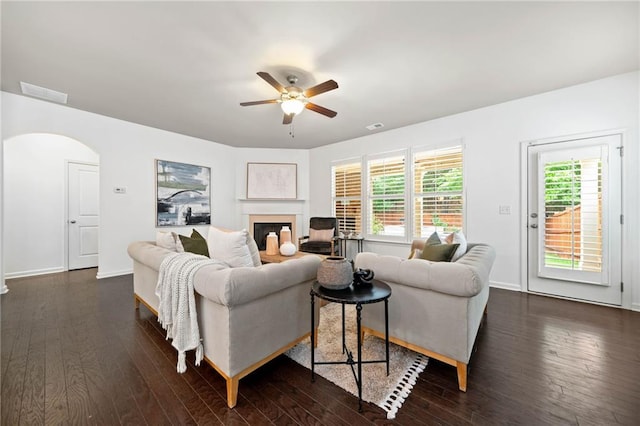 123 Meridian Dr, Woodstock, GA 30188 - living room featuring ceiling fan, arched walkways, dark wood-style floors, a glass covered fireplace, and baseboards