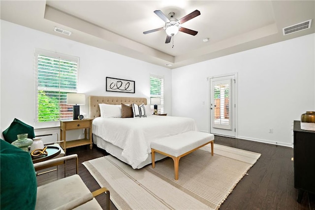 123 Meridian Dr, Woodstock, GA 30188 - bedroom featuring a tray ceiling, access to exterior, dark wood finished floors, ceiling fan, and baseboards